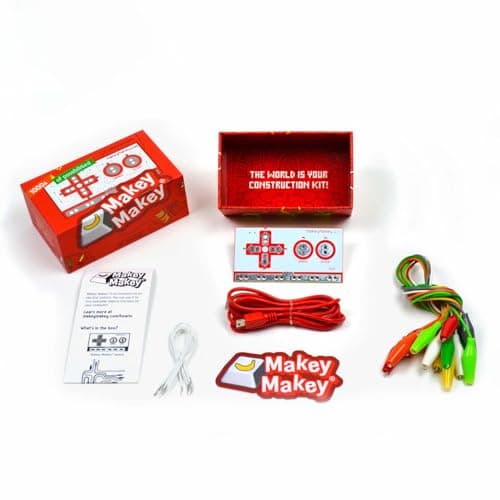 Everything included in the Makey Makey Classic box: the circuit board, red USB cable, connector wires, crocodile clips, stickers and instructions