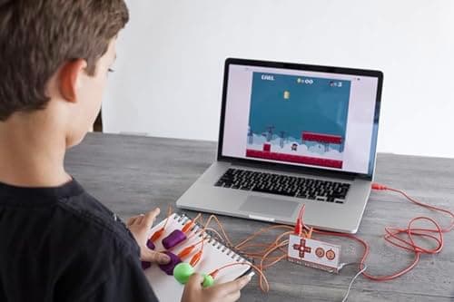 A child playing a platform game on a laptop using play-dough game controllers connected to a Makey Makey