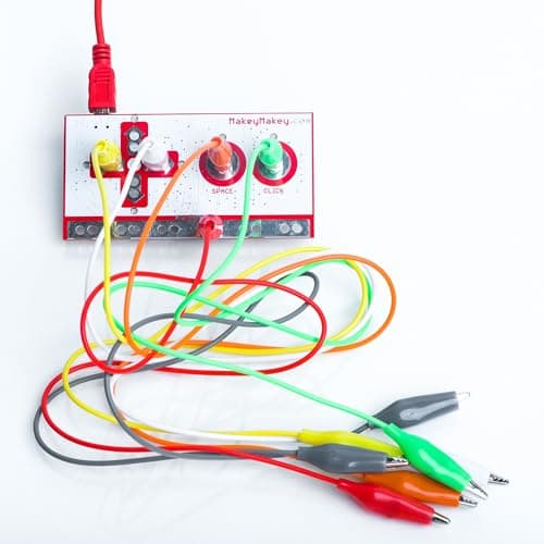 Close-up of the Makey Makey board with colourful connector wires and crocodile clips attached