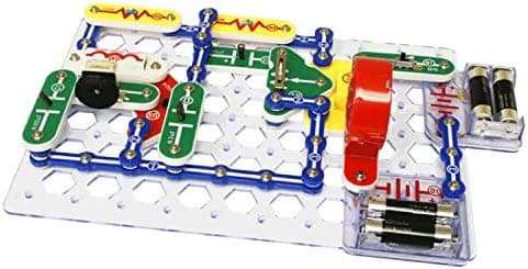 Child-friendly Snap Circuits project showing a completed working circuit with lamp and switch built on the grid baseplate