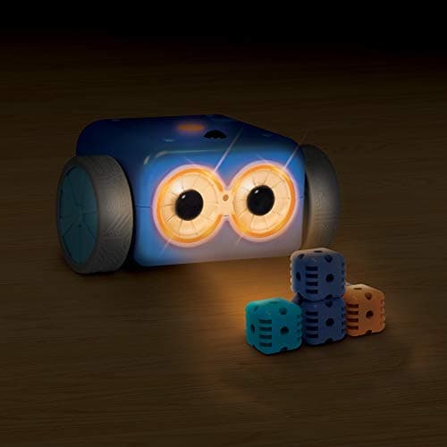 Botley 2.0 with glowing eyes in a dark room, three activity-set cubes in front