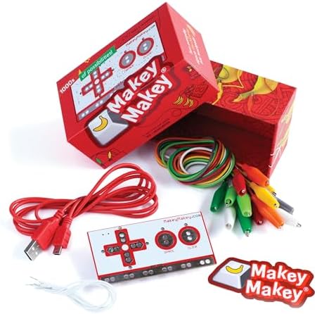 Makey Makey Classic invention kit showing the red box, USB cable, rainbow crocodile clip wires and the white circuit board