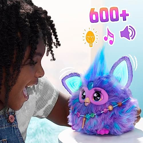 Child laughing with the purple 2023 Furby, which lights up and has over 600 responses