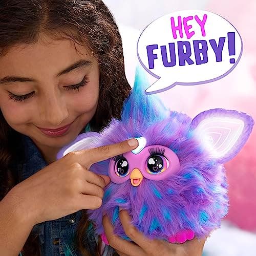 Child pressing the heart gem and saying Hey Furby to activate the interactive plush toy
