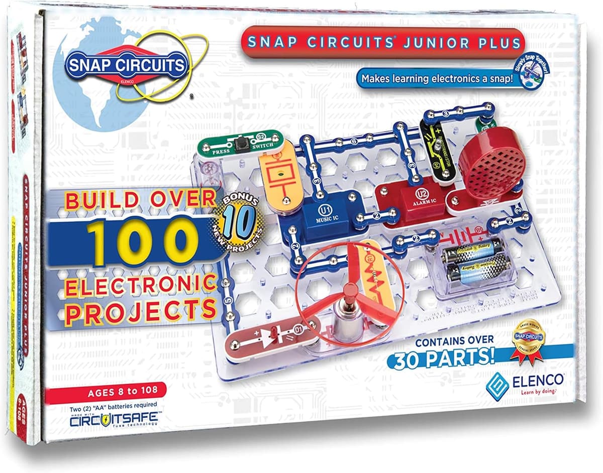 Snap Circuits Jr Plus kit with colour-coded snap pieces laid out and a working circuit on the board