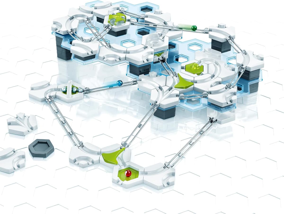 Ravensburger GraviTrax Starter Set box and contents showing hexagonal tiles, transparent rails and steel marbles